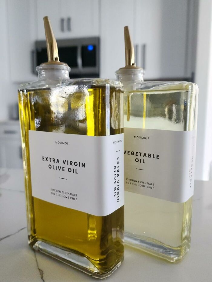 Elegant olive oil and vegetable oil bottles with stylish pourers, ideal for showoff kitchen essentials.