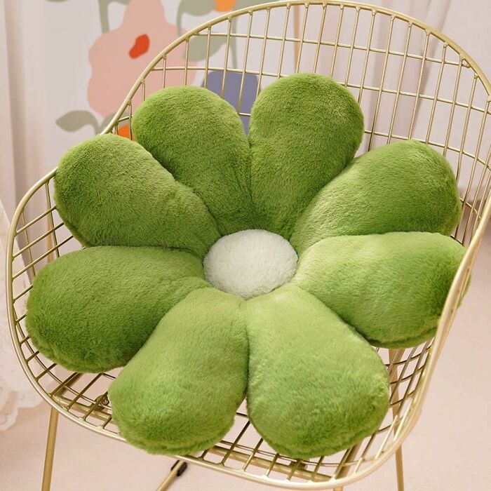 Retro Fever: Green plush flower cushion on a gold wire chair with floral art background.