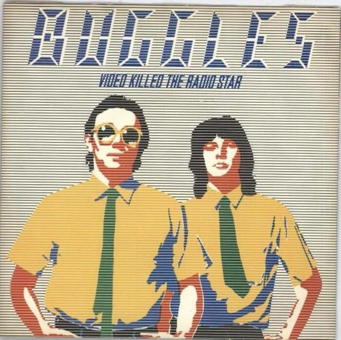 Two stylized figures in yellow shirts and green ties from a '70s pop album cover.