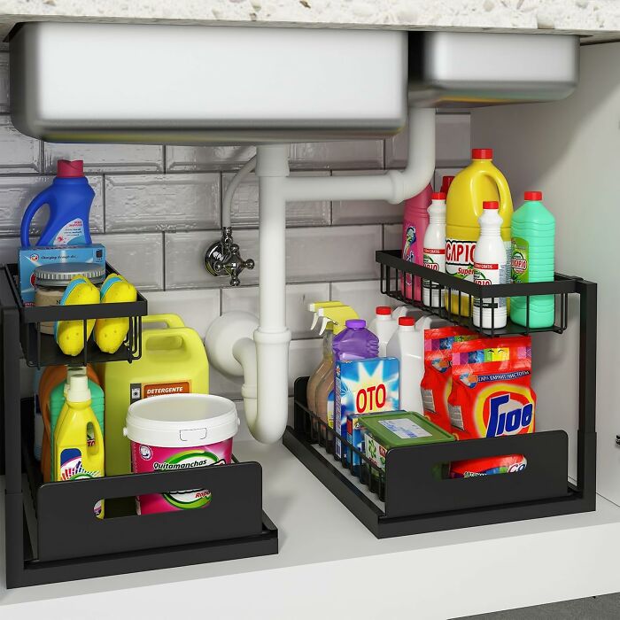 Under-sink storage with organized cleaning supplies, featuring modern racks for a more put together kitchen in 2025.