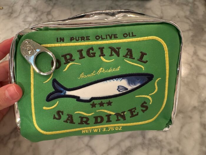 Unique sardine can clutch bag on marble counter, ideal for showoffs.