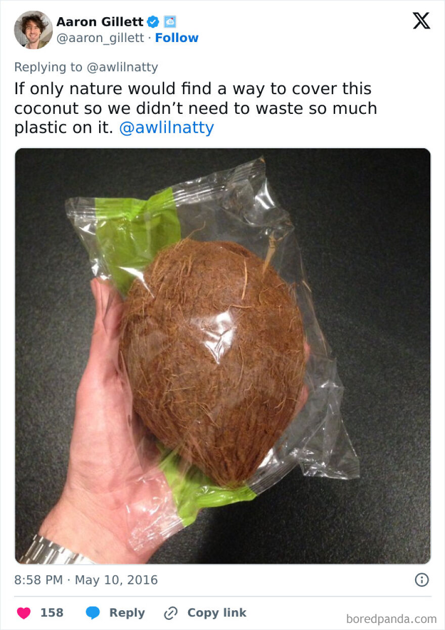 Hand holding a coconut wrapped in plastic, highlighting wasteful unnecessary packaging.