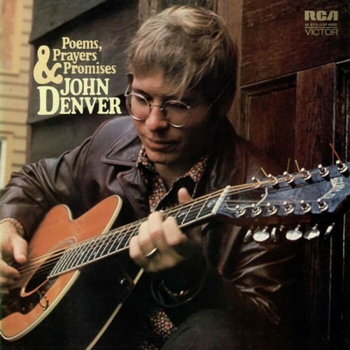 '70s song album cover featuring a musician playing a guitar, wearing glasses and a leather jacket.