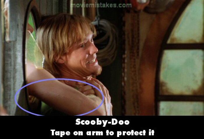 Actor in a Scooby-Doo scene with visible tape on arm, highlighting a funny movie mistake.