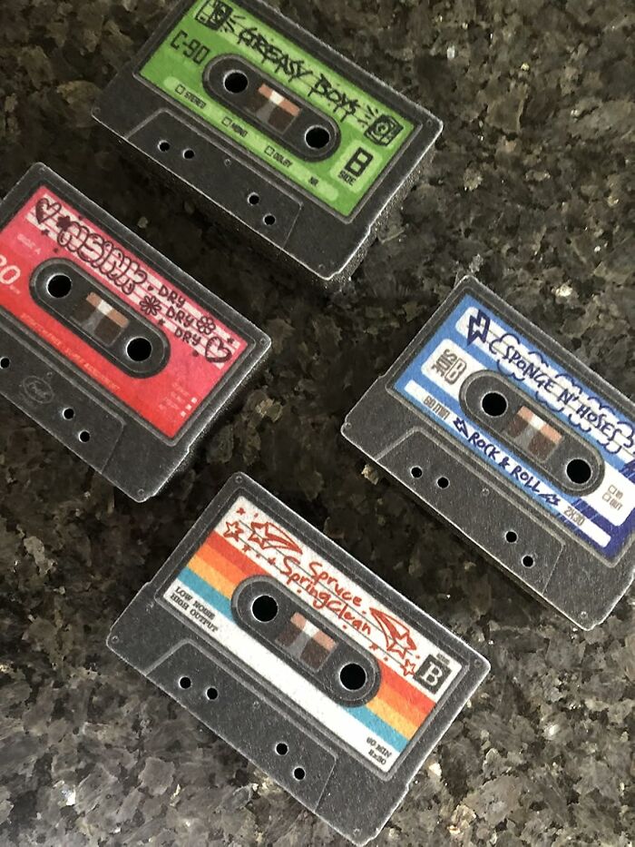 Retro Fever: Four vintage cassette tapes with colorful labels on a dark textured surface.