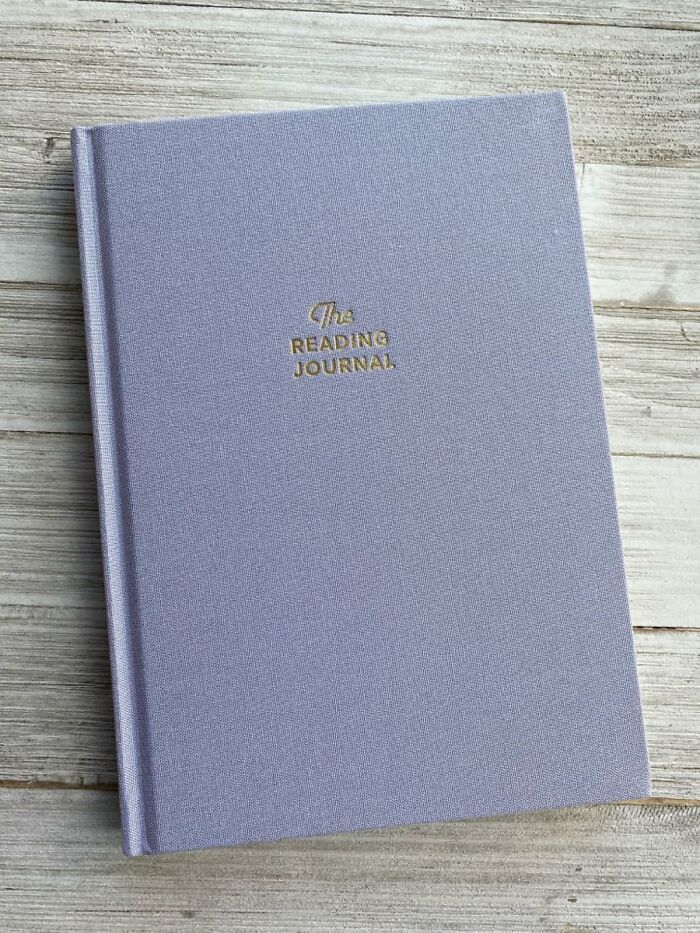 Gray reading journal on wooden background, perfect for Valentines Day finds.