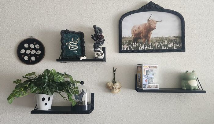 Decorative shelves with plants, art, and figurines add joy to the home's ambiance.