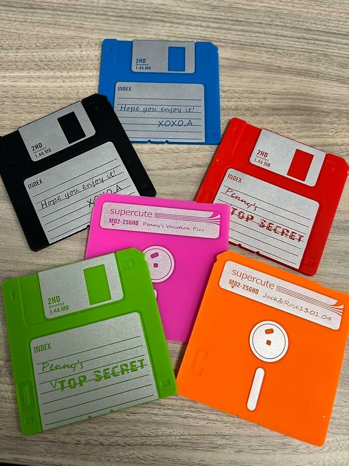 Colorful floppy disks as fun office supplies on a wooden surface.