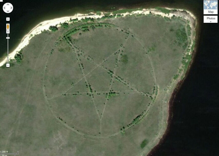 Pentagram shape on a field near water, discovered on Google Earth, intriguing viewers with its mysterious design.