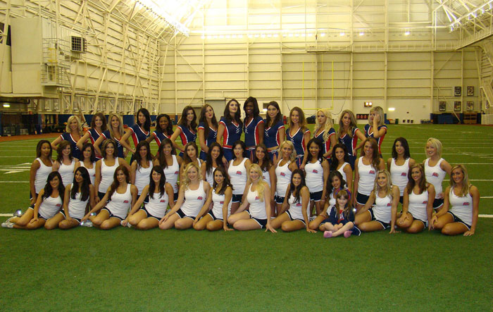 Buffalo Bills cheerleaders group photo taken inside a large indoor sports facility.