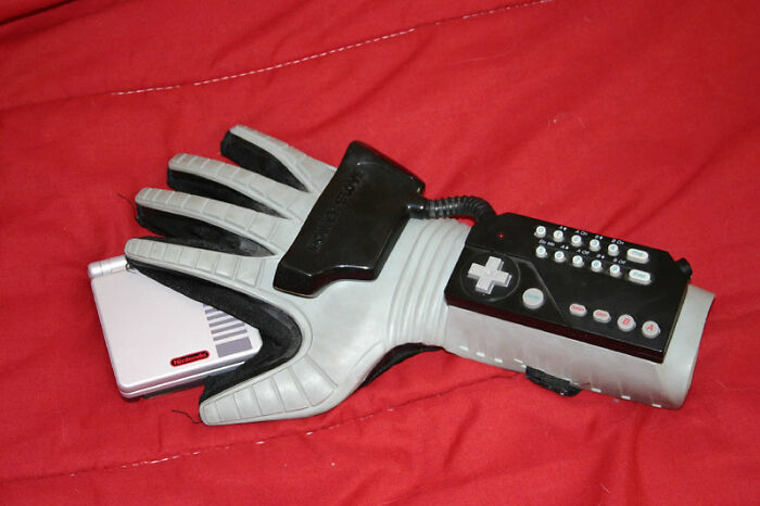 Retro gaming glove on red fabric, showcasing historical inventions ahead of their time.