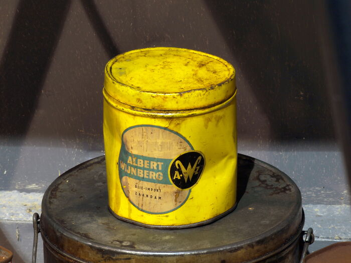 Yellow vintage tin can, an example of historical inventions ahead of their time.