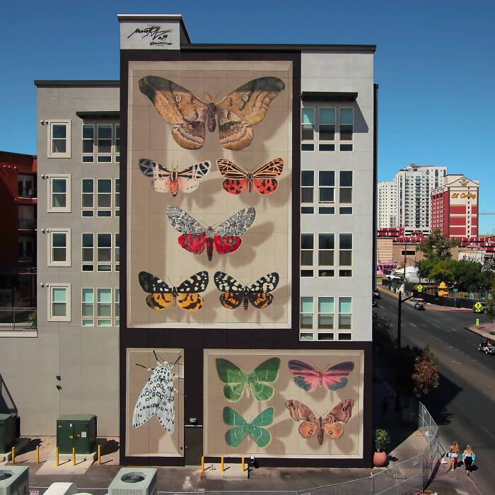 Hyper-realistic mural of accurate butterflies painted by a French artist on a building facade.