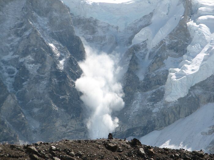 Avalanche cascading down a snow-covered mountain, showcasing stunning natural phenomena.