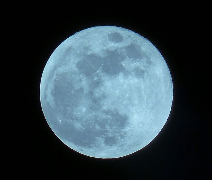 A stunning full moon against a dark sky, showcasing incredible natural phenomena.