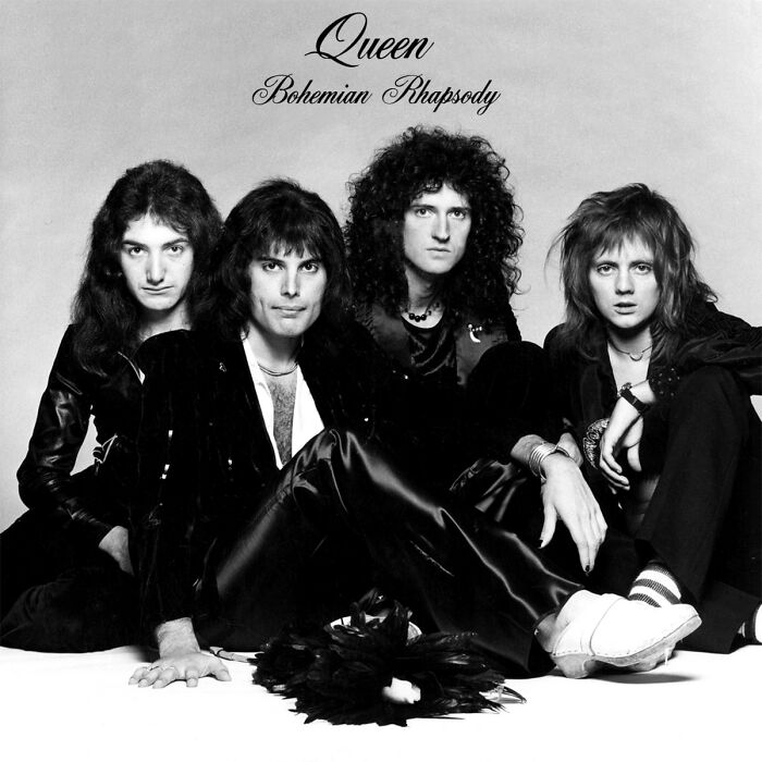 Band from the '70s posing for the "Bohemian Rhapsody" cover in black and white.