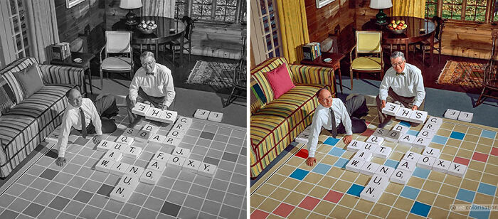 Colorized vintage photo of two men playing a large floor Scrabble game in a cozy living room.