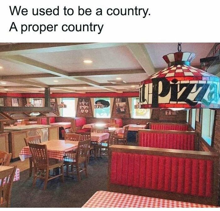 Nostalgic meme of vintage pizza restaurant interior with red booths and checkered tablecloths.