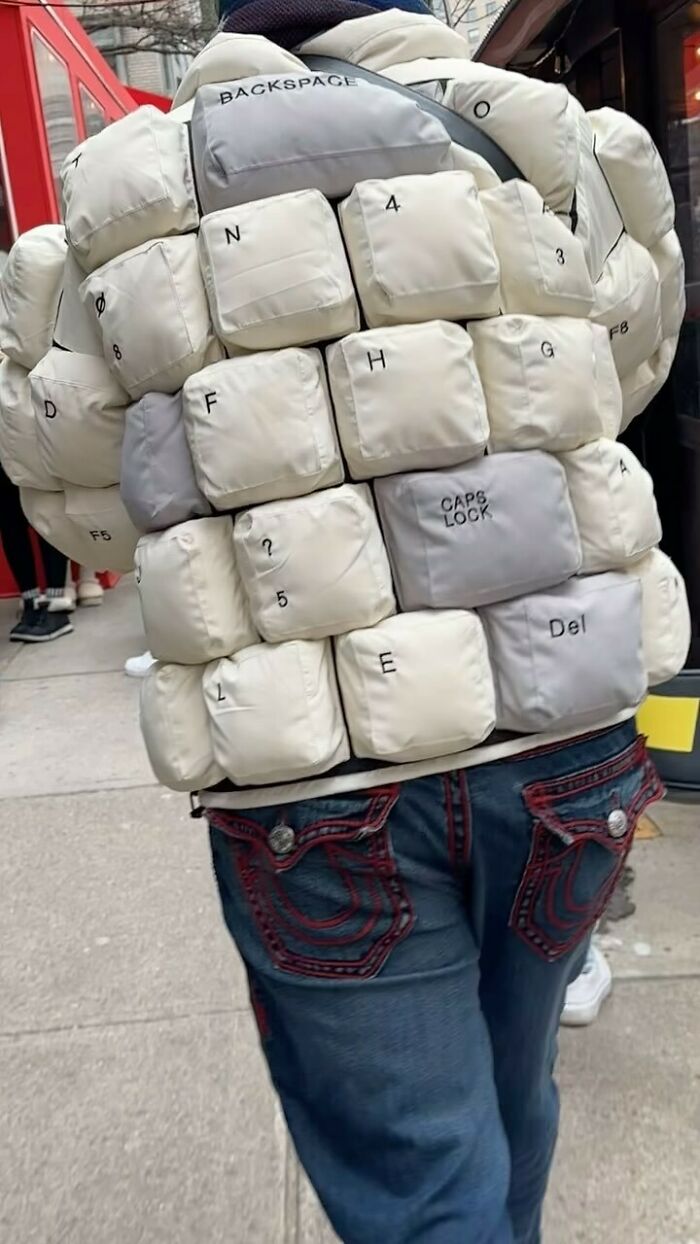 A New Yorker wearing a bold jacket styled like keyboard keys, showcasing experimental fashion.