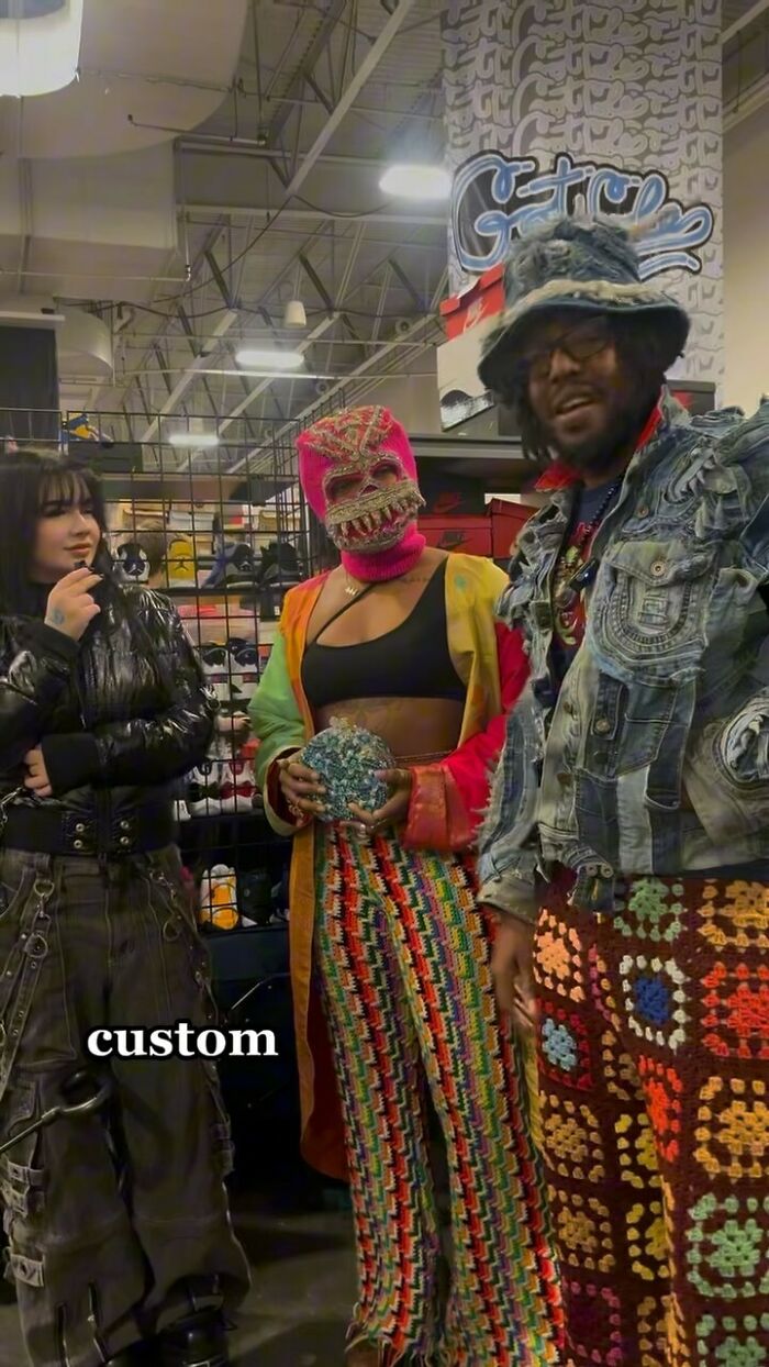 NYC locals experimenting with bold fashion: colorful crochet pants, denim jacket, and vibrant mask in a trendy setting.