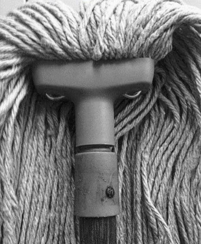 Bizarre photo of a mop head resembling a face with eyes, showing an eclectic and humorous perspective.