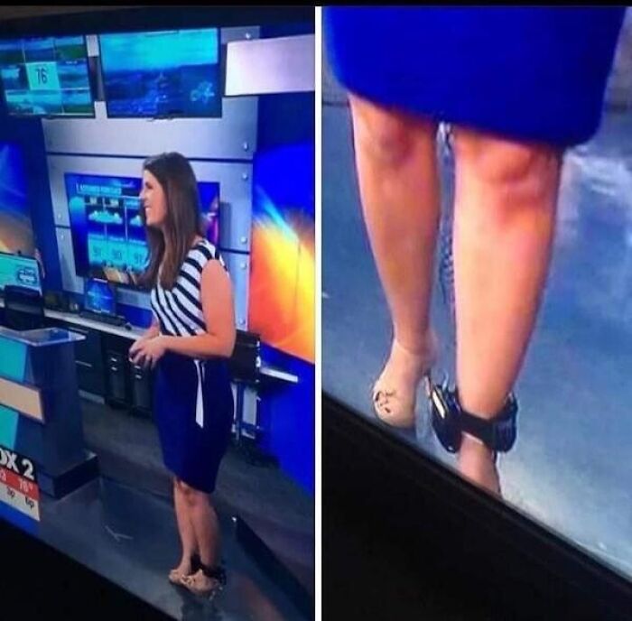 News anchor with ankle monitor, wearing blue dress and striped top, stands in studio.