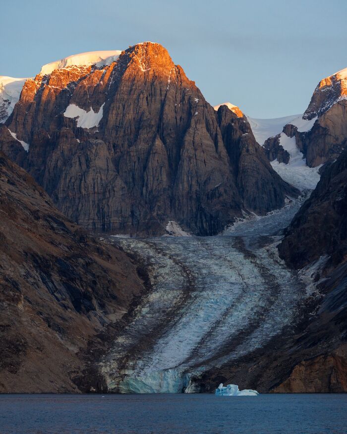 Golden light on a rugged mountain and glacier, captured by nature photographer Jeroen Van Nieuwenhove.