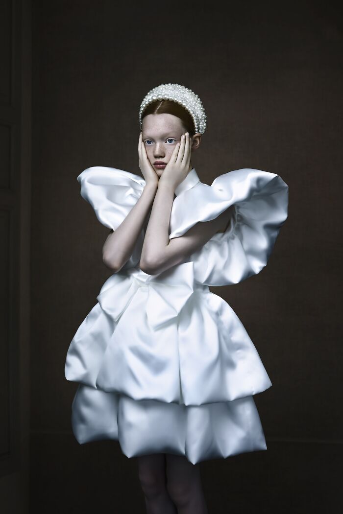 A young model in avant-garde white dress featured in Tokyo International Foto Awards.