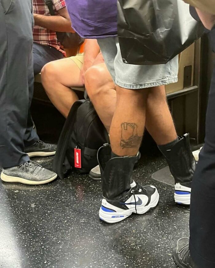 New York local on subway, wearing unique fashion: sneakers with attached black shin guards, and denim shorts.