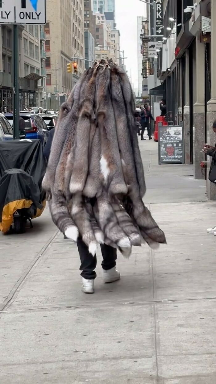 NYC local wearing a creative, fur-inspired outfit, showcasing experimental street fashion on a bustling New York street.