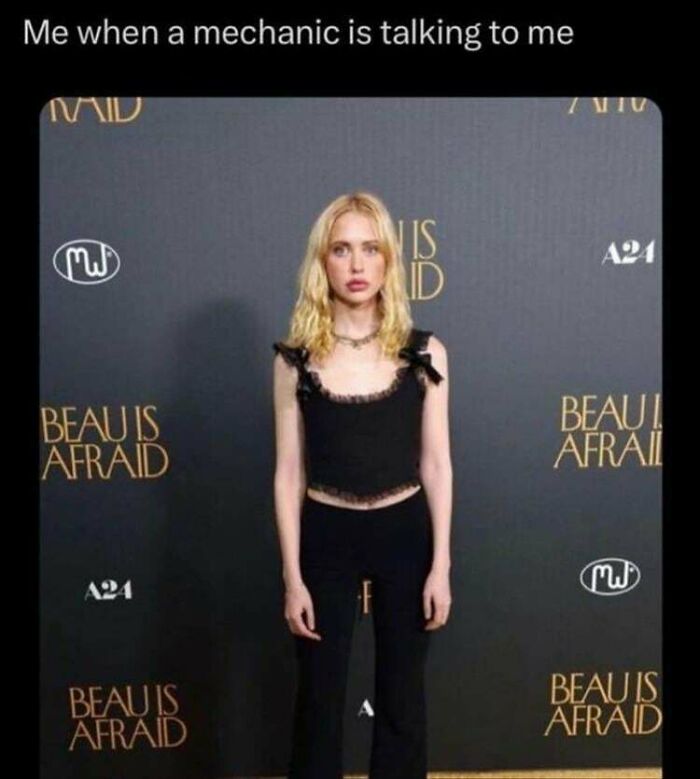 Woman in a black outfit with a blank expression at a "Beau is Afraid" event, captioned humor for women.