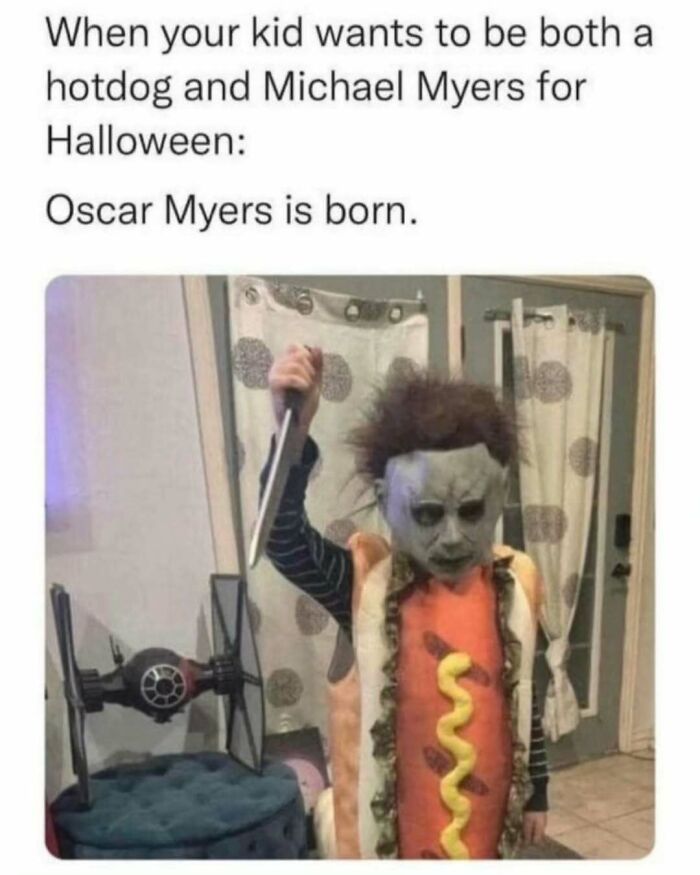 Child in a hotdog and Michael Myers costume holding a knife, humorously capturing the joys and struggles of a dad.