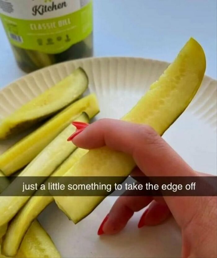 Woman with red nails holds a pickle with humorous text catering to women.