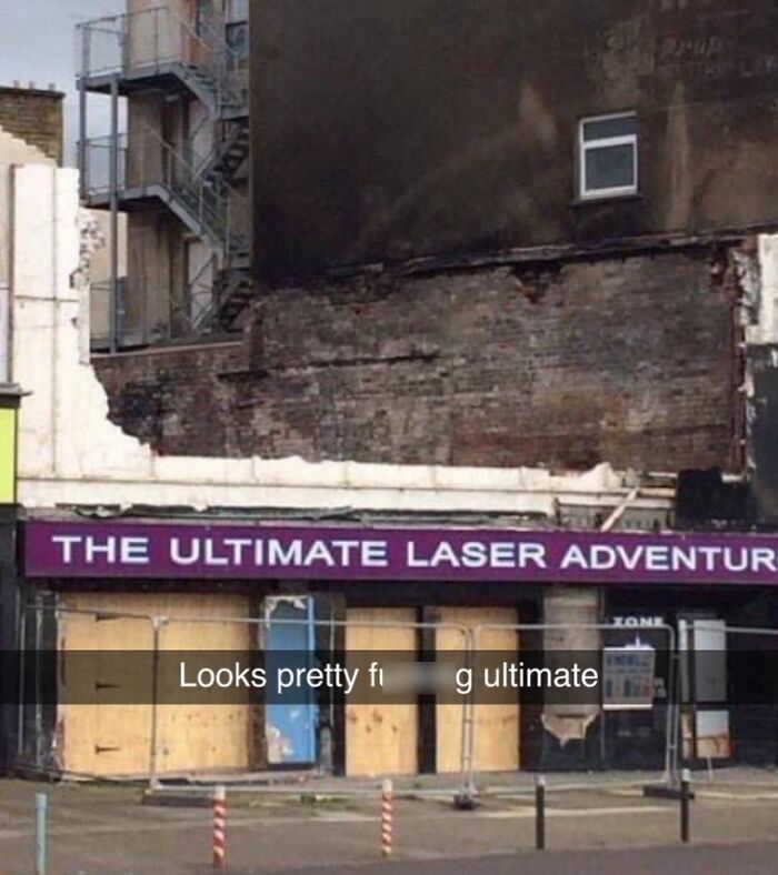 British humor: boarded-up building with "The Ultimate Laser Adventure" sign and witty caption overlay.