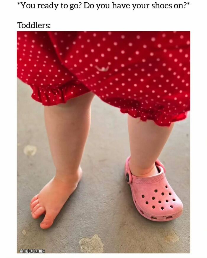 Toddler wearing one pink Croc shoe and a red polka dot dress, capturing typical dad struggles humor.