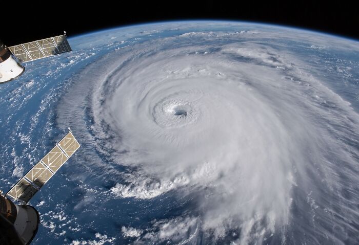 Satellite image of a stunning natural phenomenon, a massive swirling hurricane over the ocean.