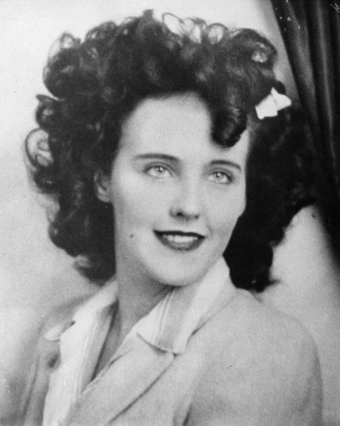 "Smiling woman from a vintage photograph connected to true crime cases with plot twists."