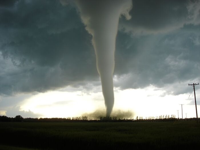 A stunning natural phenomenon: a powerful tornado under dark stormy skies.