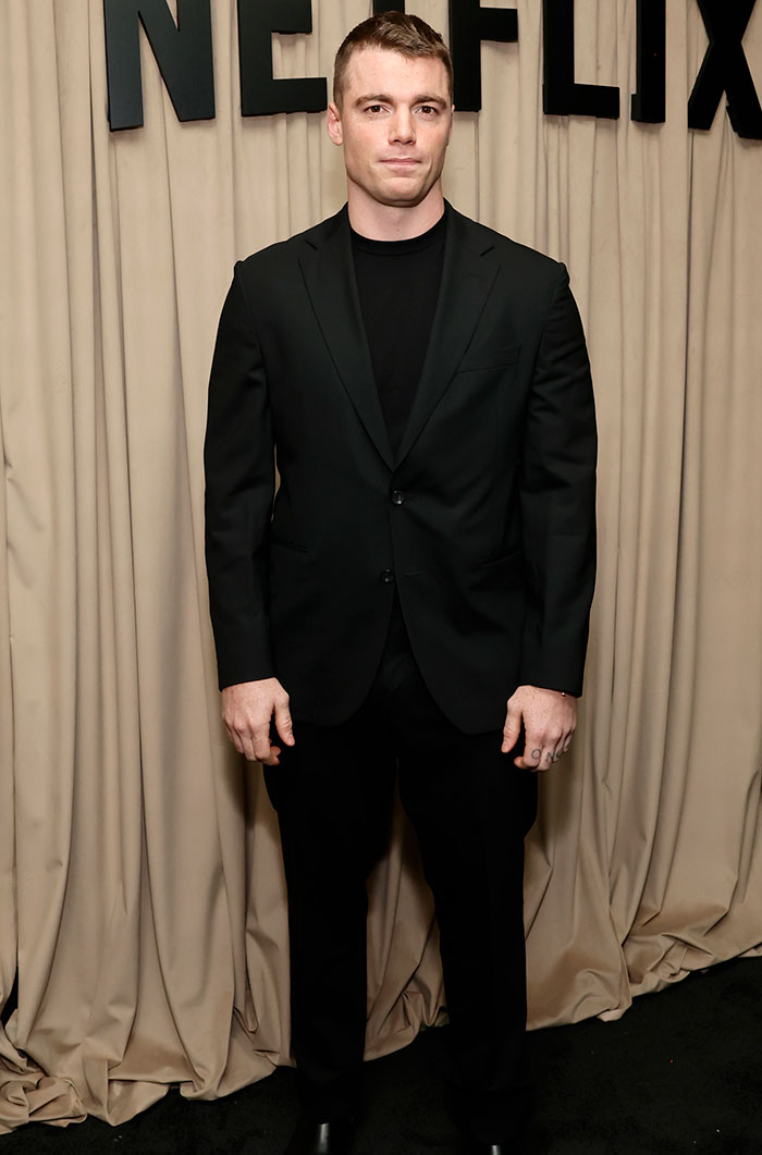 Gabriel Basso in a black suit at the Golden Globes 2025 after-party, noted as one of the worst dressed attendees.