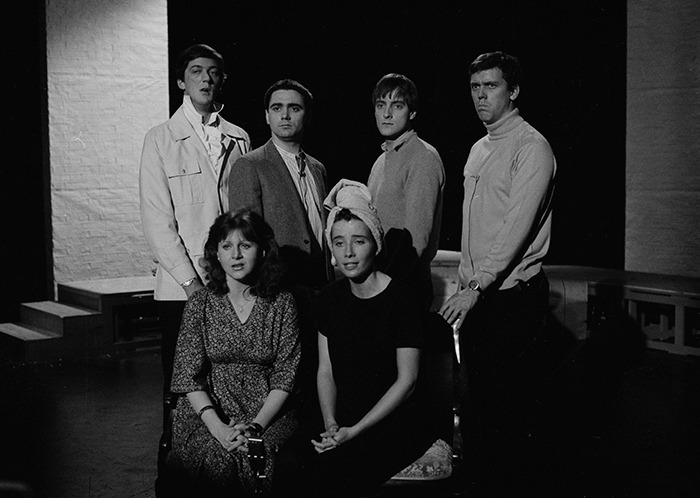 A black and white photo of a group of actors on stage, including "Whose Line Is It Anyway?" star Tony Slattery.