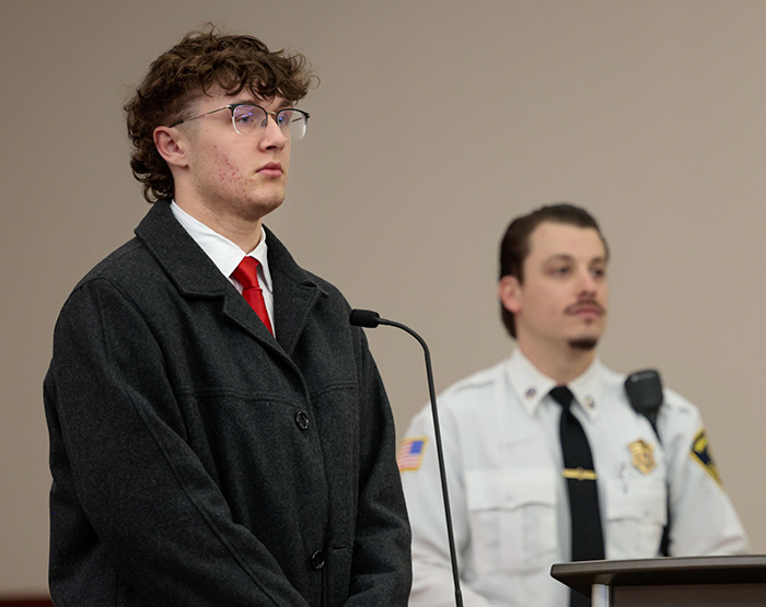 College student in court with official, related to TikTok-inspired ambush incident.