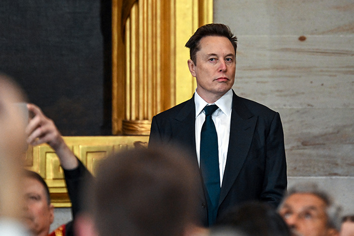 Elon Musk at a presidential inauguration, sparking memes with a mention of Mars, standing in a suit.