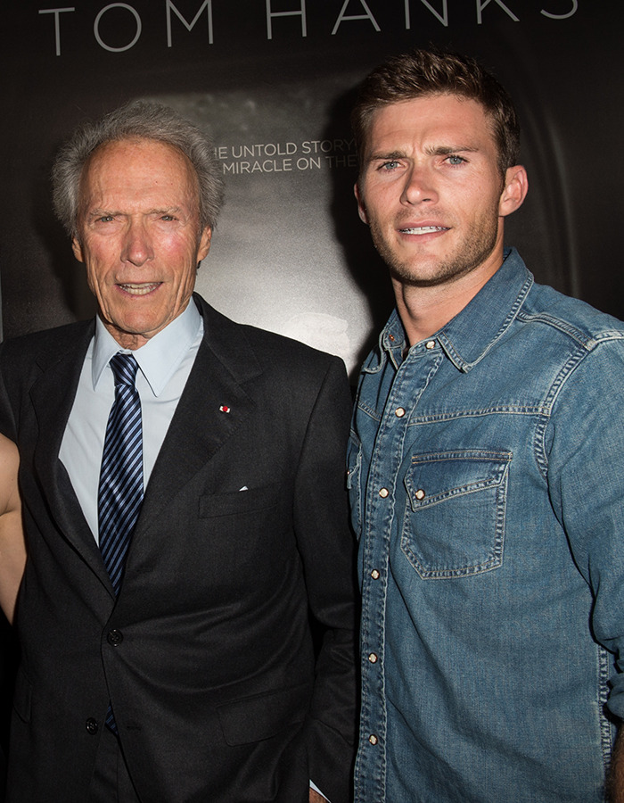 Clint Eastwood and his son standing together, both in formal attire, at a movie premiere event.