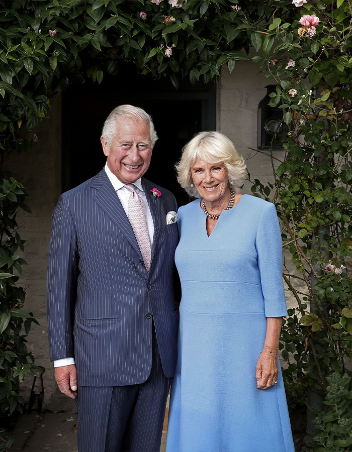 Royal couple posing outdoors, surrounded by greenery, with smiles; related to the UK dentist shortage discussion.