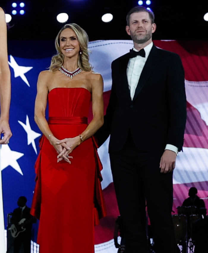 A woman in a red gown and a man in a tuxedo at a presidential inauguration event.