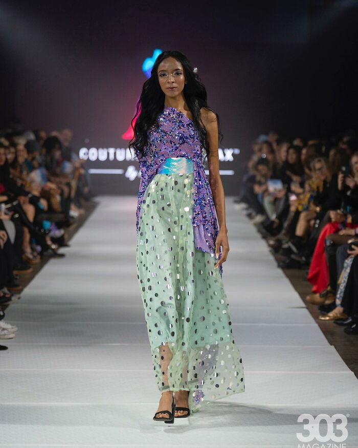 Fashion prodigy runway show featuring model in a colorful sequin and sheer dress.