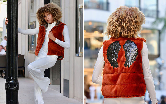 Young fashion prodigy in orange fur vest with wing design details, showcasing creative style.