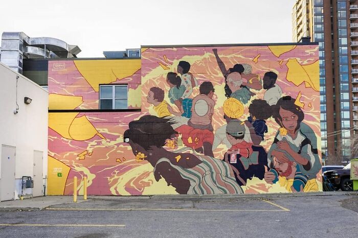 Epic mural by Montréal artist transforming a dull wall with vibrant characters and dynamic colors.