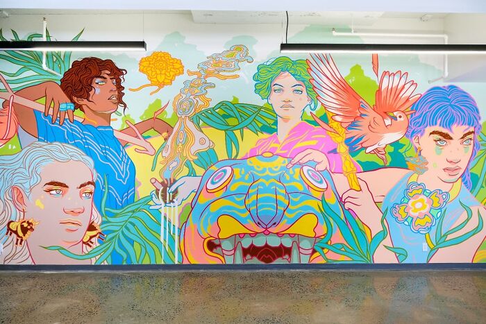 Colorful mural by Montréal artist featuring diverse figures and vibrant animals.