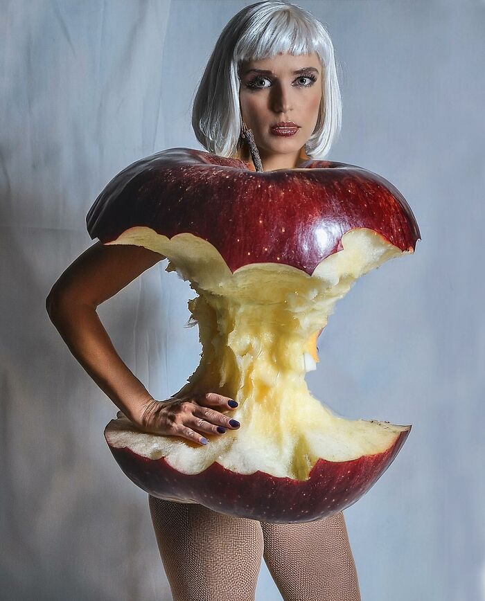 Turkish artist creates unexpected collage of a woman with apple core attire, blending reality and surrealism.